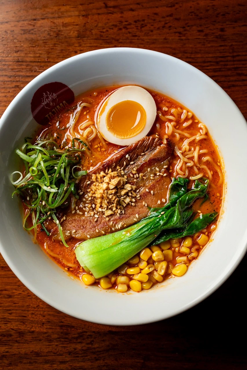 Tajima Red ramen with red bomb, chashu and baby bok choy on tonkotsu broth